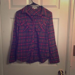 A red flannel with blue, yellow, and white accents